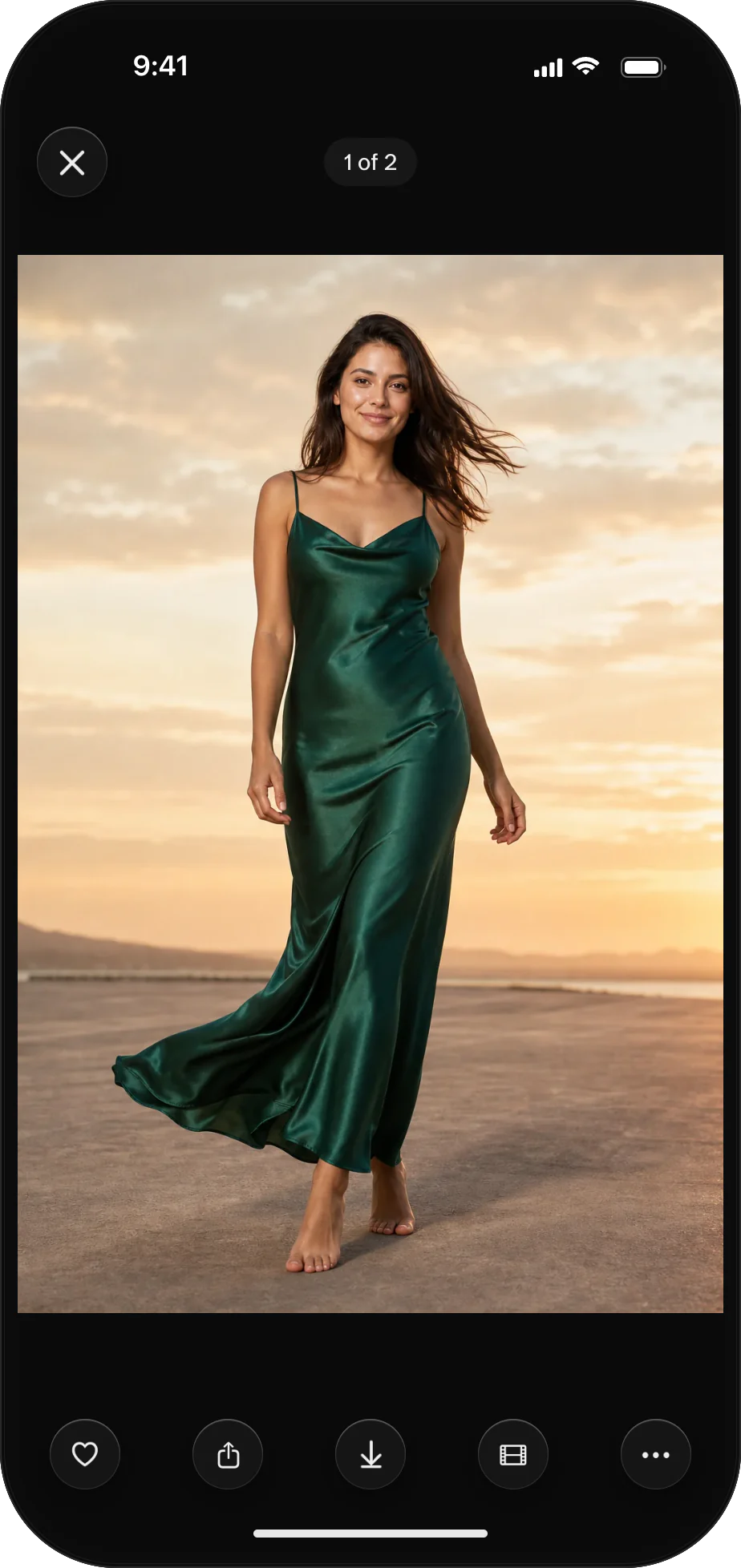 The AURA iPhone app's photo viewer showing a finished photo of a woman in an emerald slip dress on a beach at sunset